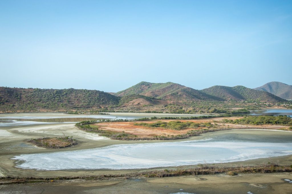 A stunning aerial landscape with sprawling hills, clear skies, and lakes reflecting the tranquility of nature.