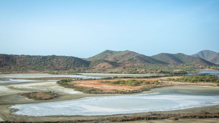 A stunning aerial landscape with sprawling hills, clear skies, and lakes reflecting the tranquility of nature.