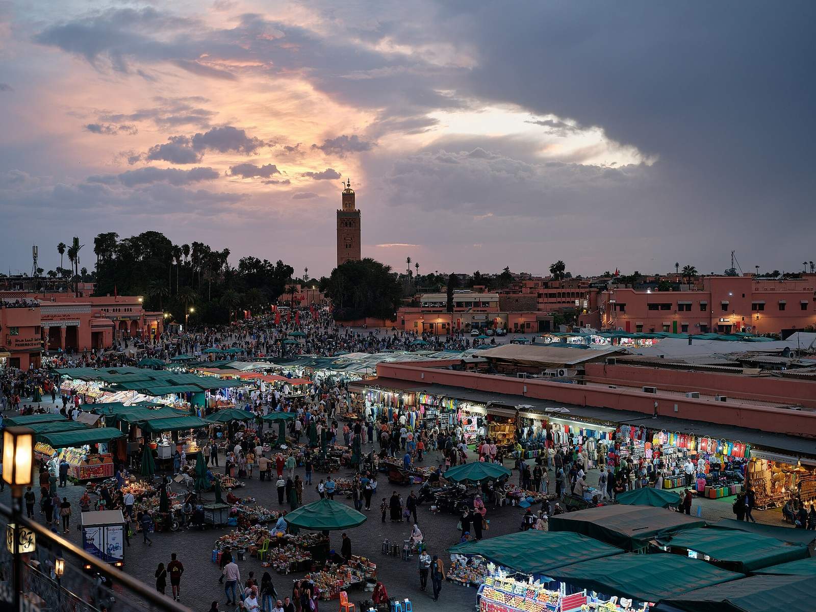 Place Jemaa el-Fna à Marrakech au coucher du soleil, avec le minaret de la Koutoubia